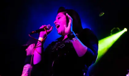 female singer in blue stage light