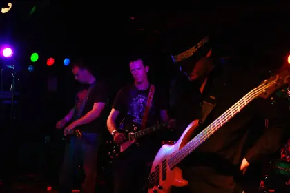 three members of a band prepare to begin playing