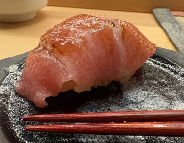 close up of sushi and chopsticks