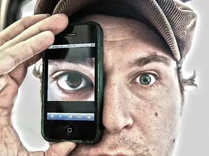 man holding phone with an image of an eye over his own eye